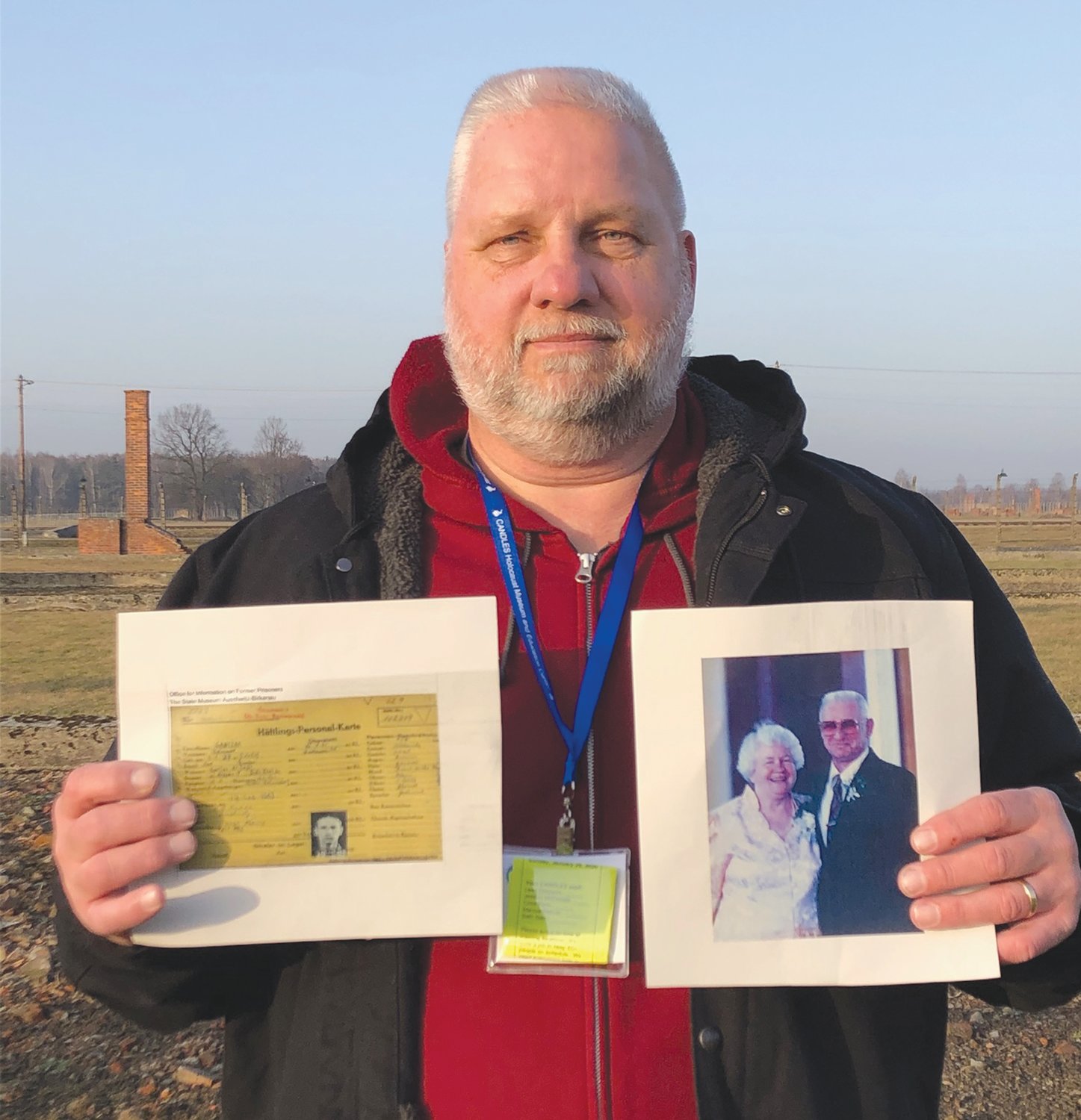 Tony Gonczarow, a Southmont High School teacher, holds his father’s record and a photograph of his parents during the 75th anniversary of the liberation of Auschwitz on Monday.